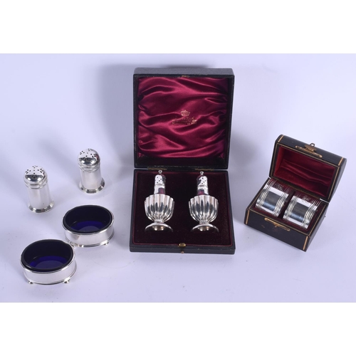 806 - A CASED PAIR OF SILVER CONDIMENTS Birmingham 1876 & a pair of Napkin rings Sheffield 1897 & a plated... 