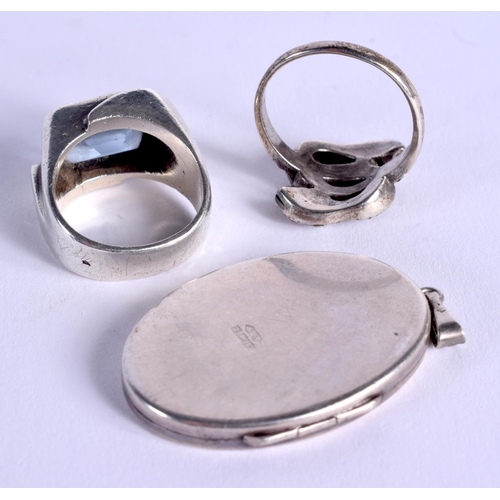 829 - TWO VINTAGE SILVER RINGS and a 1970S silver locket. 27 grams. (3)