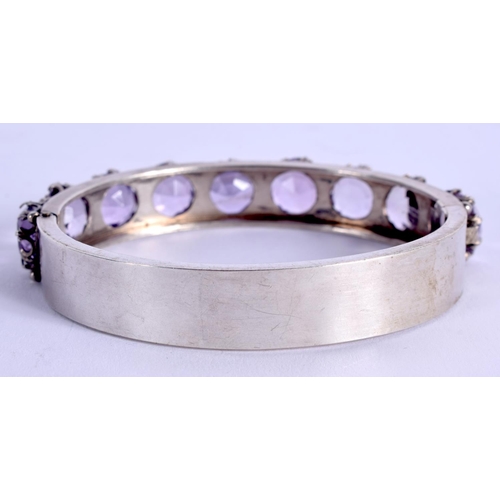 842 - AN ART DECO SILVER AND AMETHYST BANGLE. 29 grams. 6 cm x 7 cm.