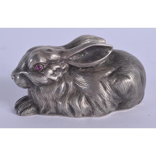 889 - A CONTINENTAL SILVER AND RUBY EYED FIGURE OF A RABBIT. 53 grams. 5.5 cm x 3 cm.