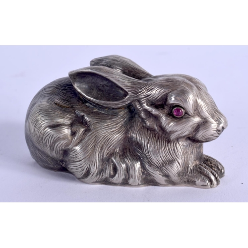 889 - A CONTINENTAL SILVER AND RUBY EYED FIGURE OF A RABBIT. 53 grams. 5.5 cm x 3 cm.