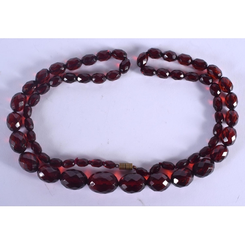 899 - A CHERRY AMBER TYPE NECKLACE. 56 grams. 80 cm long.