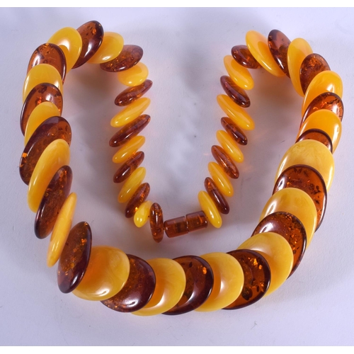 900 - AN AMBER NECKLACE. 132 grams. 54 cm long.