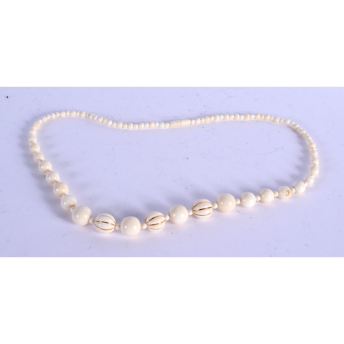 911 - A 1920S EUROPEAN GOLD AND IVORY NECKLACE. 54 cm long.