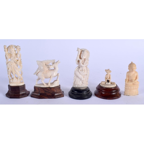 957 - A 19TH CENTURY ANGLO INDIAN CARVED IVORY SNAKE CHARMER together with four others. Largest 8 cm high.... 