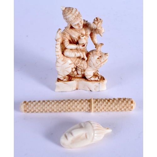 964 - A 19TH CENTURY ANGLO INDIAN CARVED IVORY BUDDHISTIC DEITY together with two others. Largest 9 cm lon... 