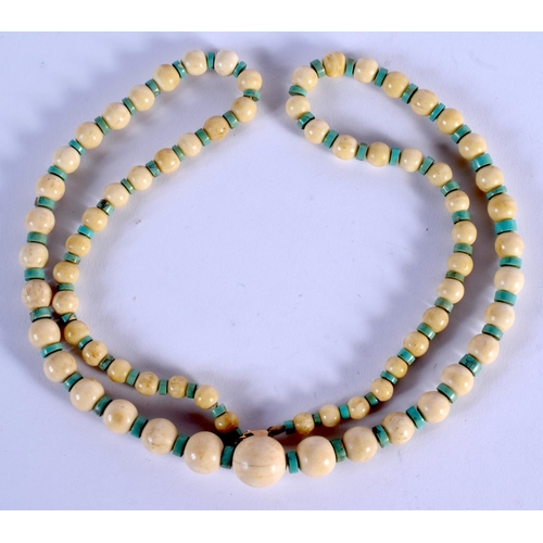 969 - AN ANTIQUE IVORY AND TURQUOISE NECKLACE.  70 cm long.