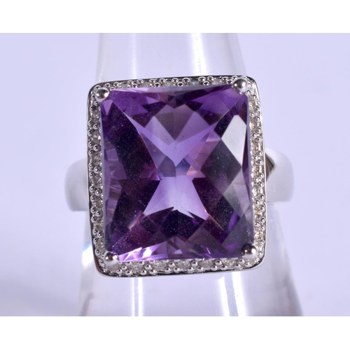 979 - A 14CT GOLD DIAMOND AND AMETHYST RING.7 grams. O.