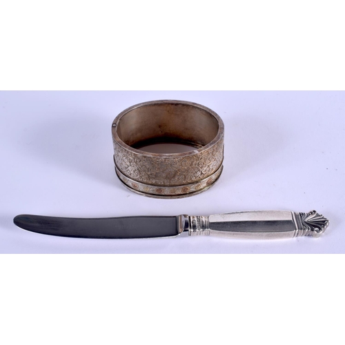 991 - A GEORG JENSEN SILVER HANDLED KNIFE and a white metal bangle. 55 grams. (2)