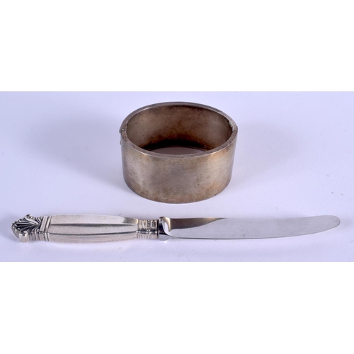 991 - A GEORG JENSEN SILVER HANDLED KNIFE and a white metal bangle. 55 grams. (2)