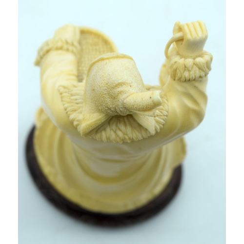 31 - AN EARLY 20TH CENTURY CHINESE CARVED CULTURAL REVOLUTION IVORY modelled roaming holding grain holdin... 