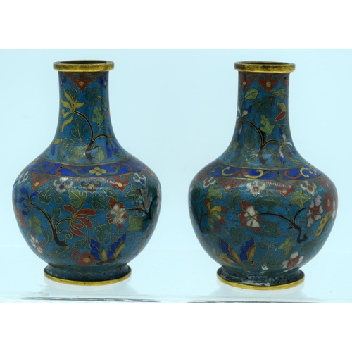 33 - A PAIR OF 19TH CENTURY CHINESE CLOISONNE ENAMEL VASES decorated with foliage and vines. 12 cm high.