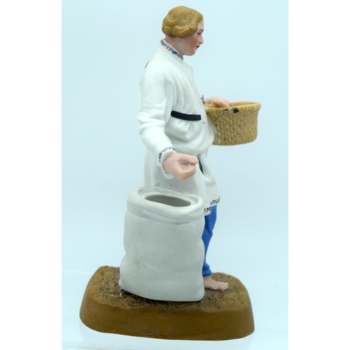 45 - A 19TH CENTURY RUSSIAN BISQUE PORCELAIN FIGURE OF A FARMER Attributed to the Gardner factory, modell... 