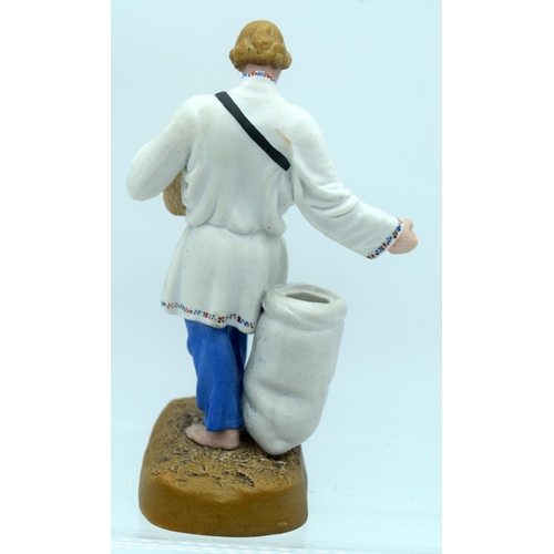 45 - A 19TH CENTURY RUSSIAN BISQUE PORCELAIN FIGURE OF A FARMER Attributed to the Gardner factory, modell... 