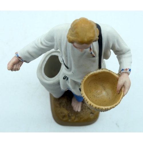 45 - A 19TH CENTURY RUSSIAN BISQUE PORCELAIN FIGURE OF A FARMER Attributed to the Gardner factory, modell... 