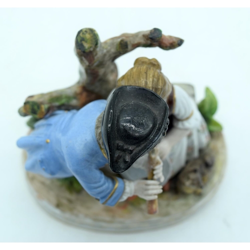 53 - AN ANTIQUE GERMAN PORCELAIN FIGURAL GROUP modelled as a boy and girl playing a pipe. 13 cm x 11 cm.