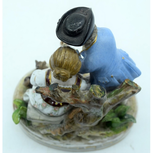 53 - AN ANTIQUE GERMAN PORCELAIN FIGURAL GROUP modelled as a boy and girl playing a pipe. 13 cm x 11 cm.