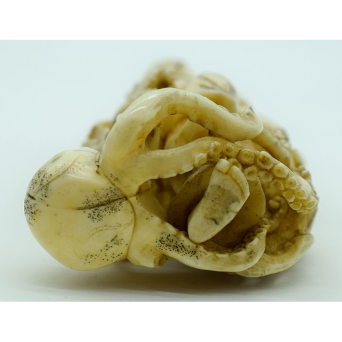 54 - A 19TH CENTURY JAPANESE MEIJI PERIOD CARVED IVORY OKIMONO modelled as a fisherman standing upon an o... 