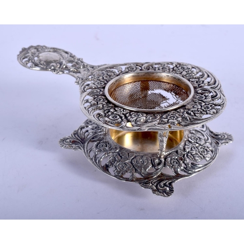 1032 - A 19TH CENTURY CONTINENTAL SILVER TEA STRAINER ON STAND. 87 grams. 12 cm x 7 cm. (2)