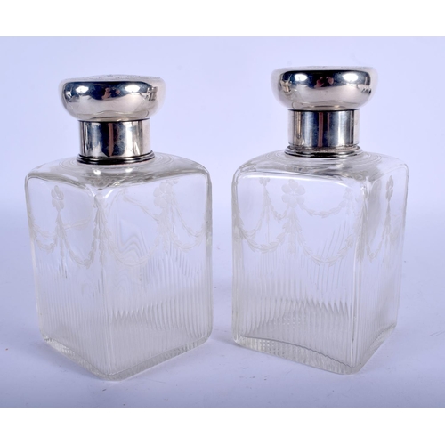 1048 - A PAIR OF ANTIQUE SILVER ENGRAVED GLASS BOTTLES. London 1916. Silver 96 grams. 15 cm x 8 cm.