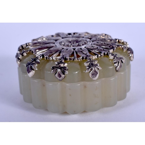 1064 - AN UNUSUAL CONTINENTAL SILVER MOUNTED JADE LOBED BOX AND COVER. 4.5 cm wide.