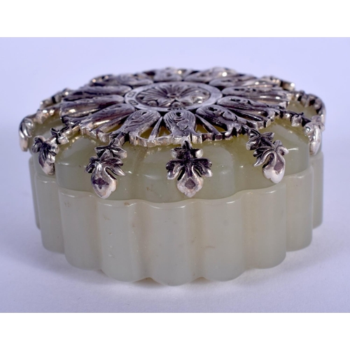 1064 - AN UNUSUAL CONTINENTAL SILVER MOUNTED JADE LOBED BOX AND COVER. 4.5 cm wide.