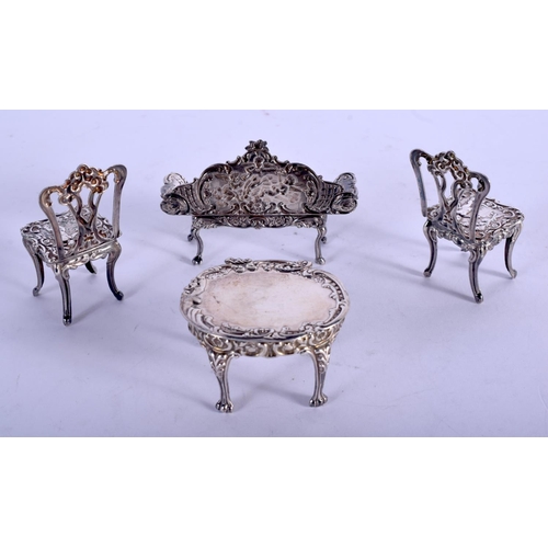 1077 - FOUR PIECES OF SILVER DOLLS HOUSE FURNITURE. Birmingham 1976. 54 grams. Largest 6 cm x 5 cm. (4)