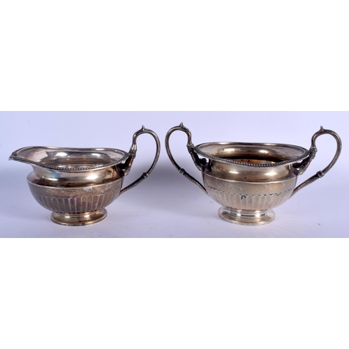 1083 - AN ART DECO SCOTTISH SILVER CREAM JUG and sugar basin. Edinburgh 1922 & 1923. 520 grams. Largest 14 ... 