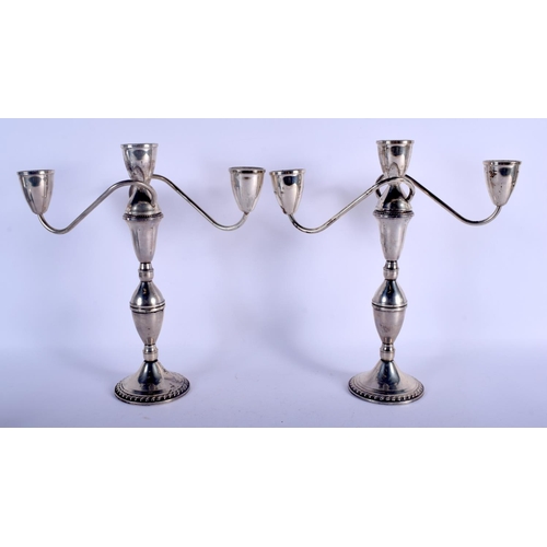 1175 - A PAIR OF STERLING SILVER CANDLESTICKS. 1380 grams weighted. 29 cm x 28 cm.