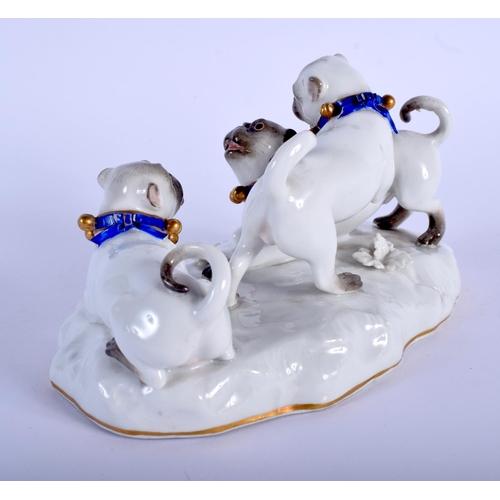 118 - A 19TH CENTURY MEISSEN PORCELAIN FIGURE OF THREE PUG DOGS modelled upon a naturalistic base. 14 cm x... 