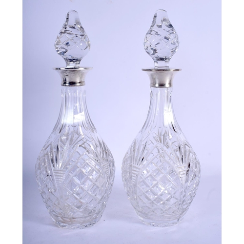 1183 - A PAIR OF 1970S ENGLISH MOUNTED SILVER DECANTERS AND STOPPERS. London 1972. 32 cm high.