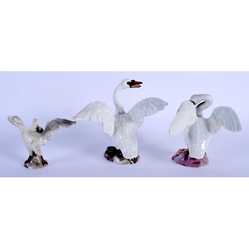 121 - THREE 19TH CENTURY MEISSEN PORCELAIN FIGURES OF SWANS modelled upon naturalistic bases. Largest 11 c... 