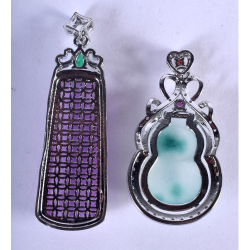 1217 - TWO SILVER AND JADE PENDANTS. 24 grams. Largest 5.5 cm. (2)