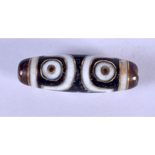 1218 - A GOLD INLAID TIBETAN ZHU BEAD. 4 cm wide.