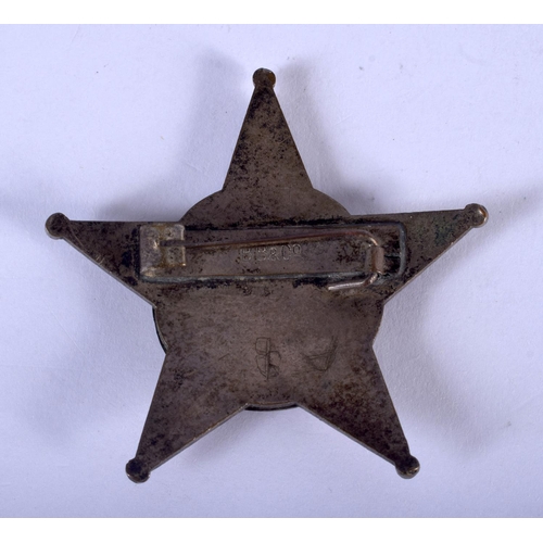 1249 - AN UNUSUAL MIDDLE EASTERN BRASS AND ENAMEL STAR BADGE. 4.5 cm wide.