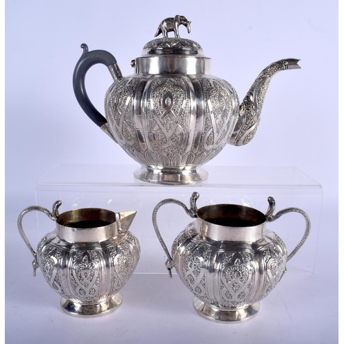 1258 - AN ANTIQUE INDIAN THREE PIECE SILVER TEASET. 858 grams. Largest 24 cm x 18 cm. (3)