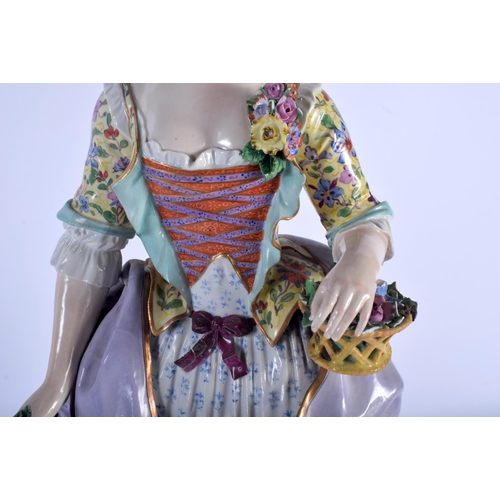 127 - A RARE LARGE 19TH CENTURY MEISSEN PORCELAIN FIGURE OF A STANDING FEMALE modelled holding a floral wr... 