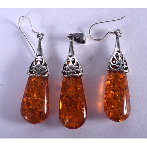 1288 - TWO SILVER AMBER EARRINGS and a pendant. 11.5 grams. 4.5 cm x 1.5 cm. (3)