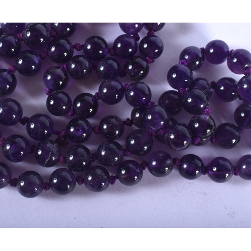 1293 - A STRING OF AMETHYST BEADS. 66 cm long.