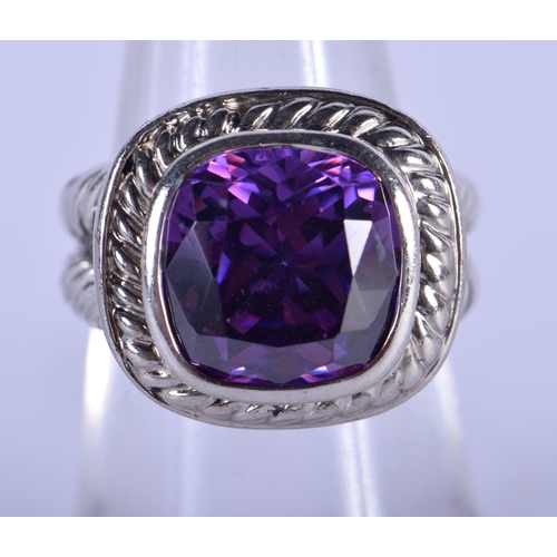 1303 - A SILVER AND AMETHYST RING. L. 7.5 grams.