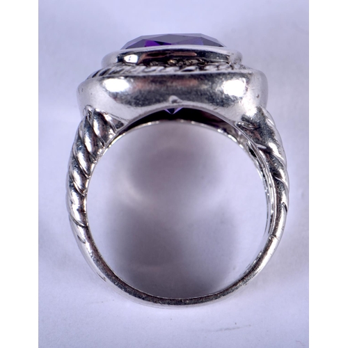 1303 - A SILVER AND AMETHYST RING. L. 7.5 grams.