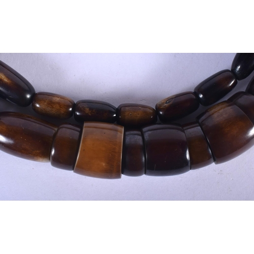 1324 - AN UNUSUAL LARGE EARLY 20TH CENTURY CARVED AND STAINED HORN NECKLACE possibly Rhinoceros, of graduat... 