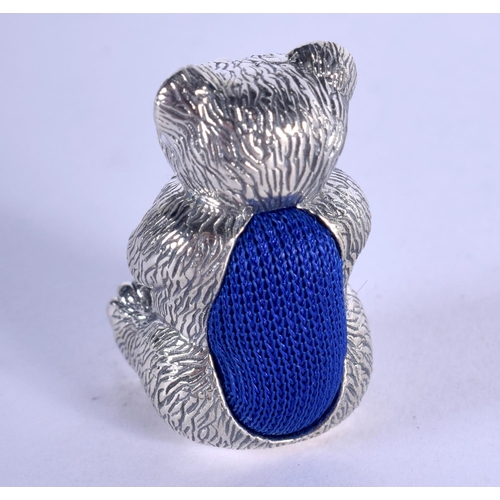 1326 - A SILVER TEDDY BEAR PIN CUSHION. 19 grams. 3 cm x 1.5 cm.