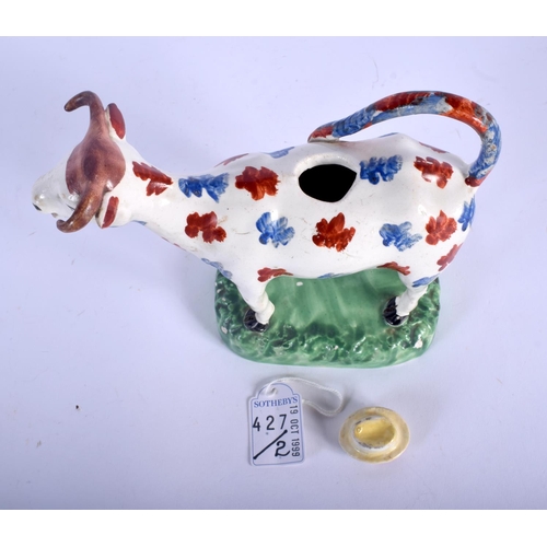 133A - A RARE EARLY 19TH CENTURY WELSH SWANSEA POTTERY COW CREAMER AND COVER C1810 painted with blue and re... 