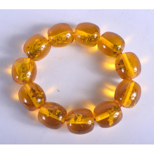 1333 - AN AMBER STYLE BRACELET. 8 cm wide.