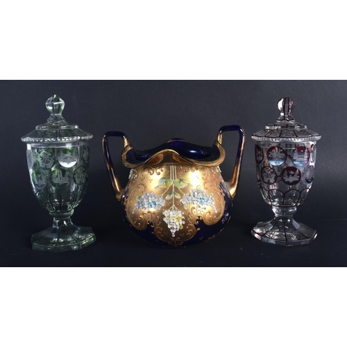 15 - A PAIR OF BOHEMIAN GLASS CUPS AND COVERS together with a twin handled bowl. Largest 13 cm x 15 cm. (... 