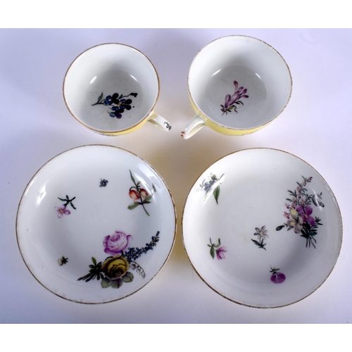 187 - 18th c. Meissen pair of yellow ground teacups and saucer painted with flowers in panels, crossed swo... 