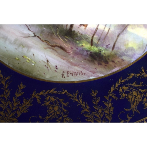 240 - Royal Worcester plate painted with cattle beside a lake beneath a blue and gilt border by George Eva... 