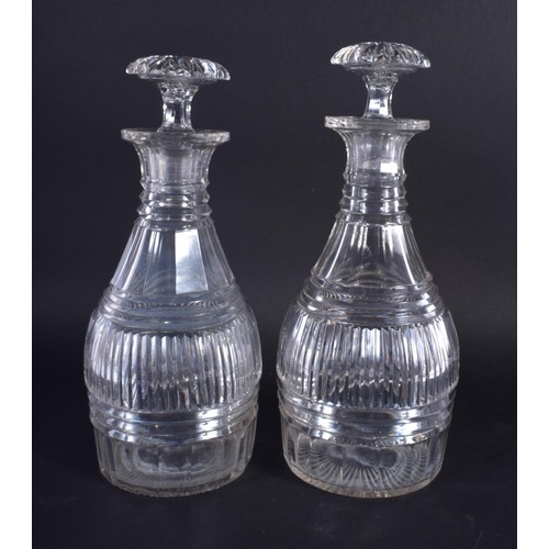 27 - A PAIR OF GEORGE III CUT GLASS DECANTERS. 22 cm high.