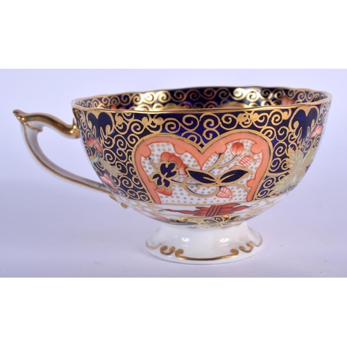 283 - Royal Crown Derby pedestal teacup, saucer and side plate painted with imari pattern 9022, date code ... 